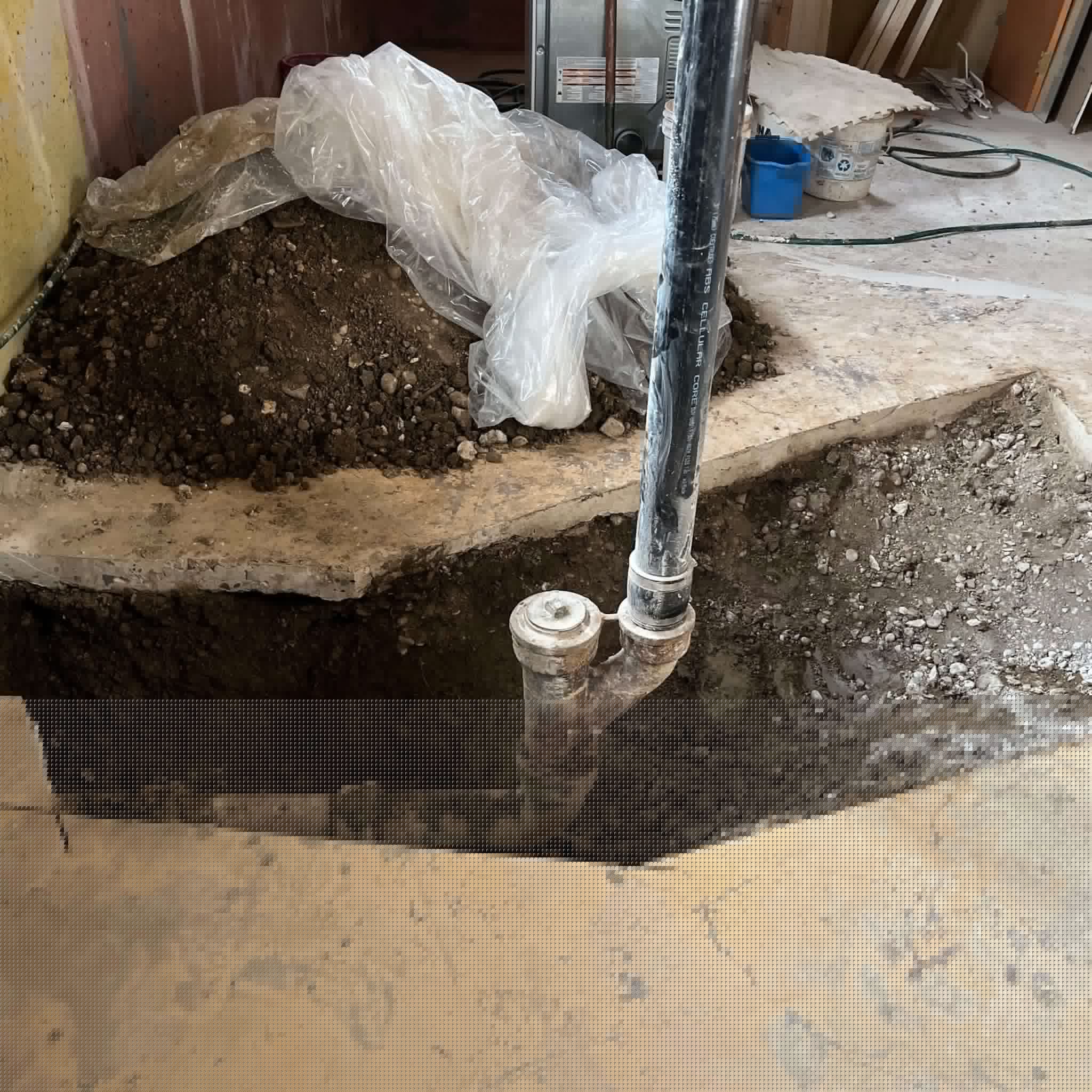 Preparing for Backwater Valve Installation in Canmore Exposed main drain in a basement floor in Canmore, prepared for backwater valve installation.