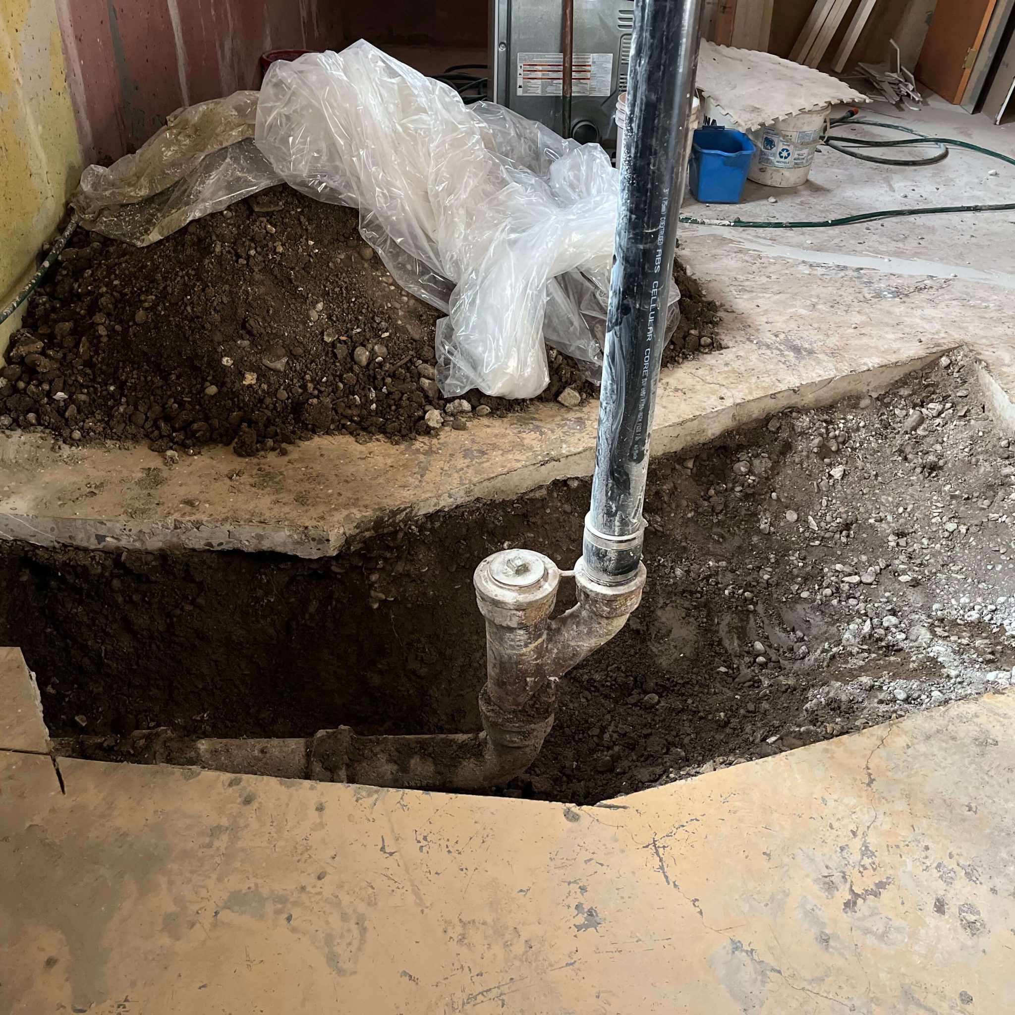 Preparing for Backwater Valve Installation in St. Albert Exposed main drain in a basement floor in St. Albert, prepared for backwater valve installation.