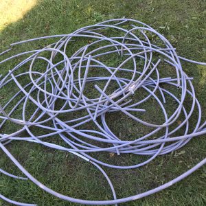 Pile of removed Poly B pipes from an Calgary, indicating extensive repiping work.