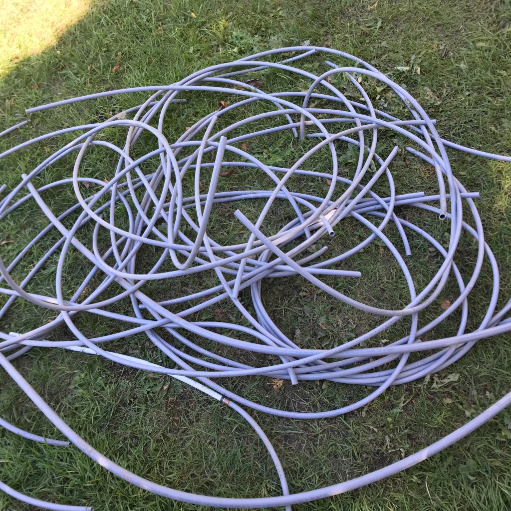 Pile of removed Poly B pipes from an Sherwood Park home, indicating extensive repiping work.