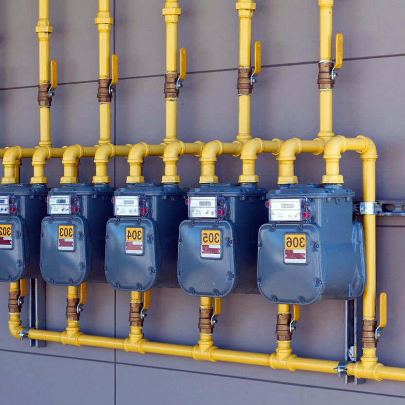 Row of gas meters installed for a commercial property in Sherwood Park as part of our gasline installation service.