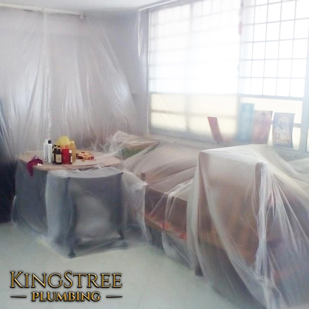 Living room in St. Albert covered with protective sheeting during Poly B repiping, ensuring property safety and cleanliness.
