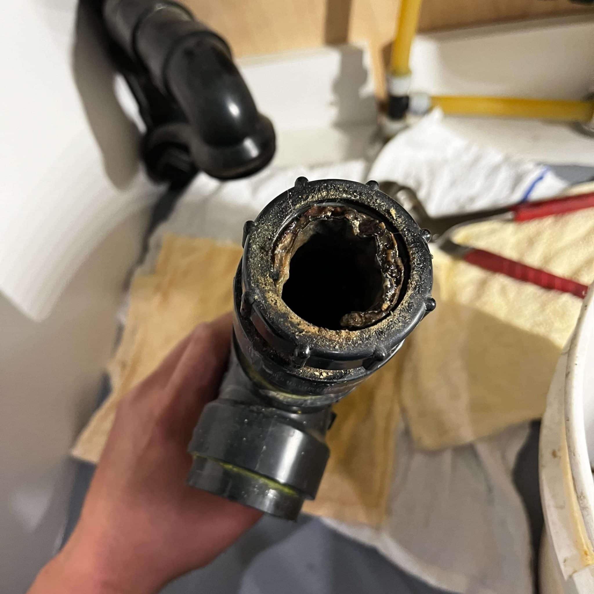 Kitchen sink drainage clogged with grease in St. Albert, cleaned by our drain cleaning experts.