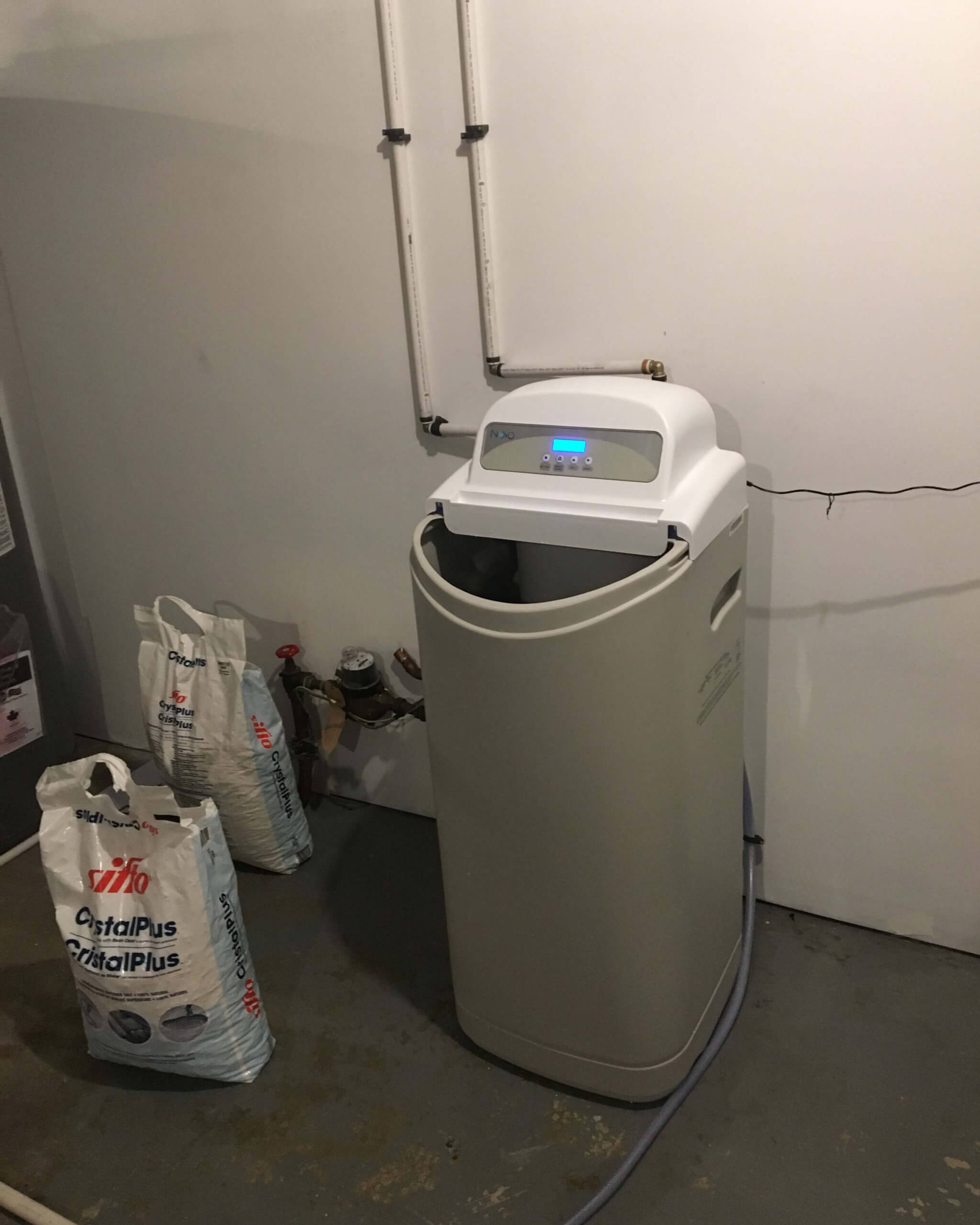 Commissioning New Water Softeners in Edmonton Technician in Edmonton commissioning a new water softener to guarantee optimal performance.